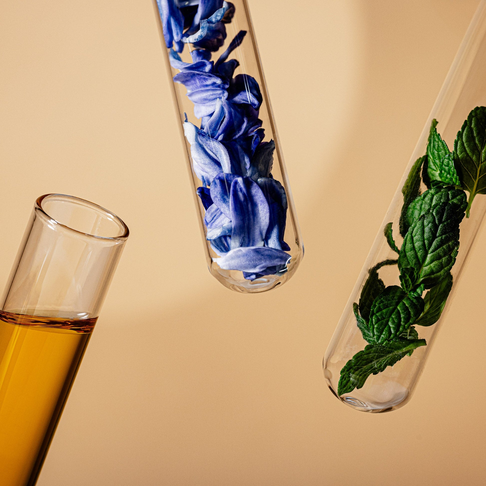 Three test tubes with different contents on a beige background